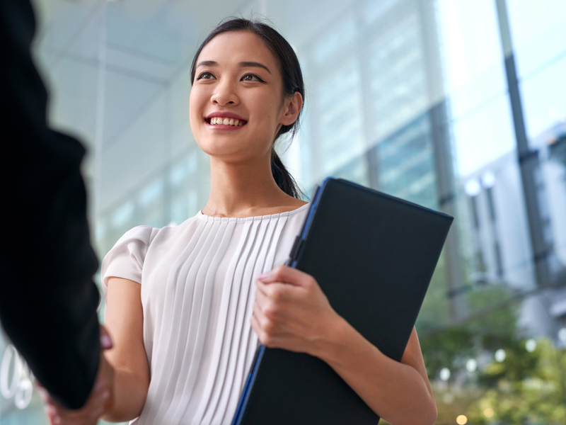 Image of a woman holding a folder.